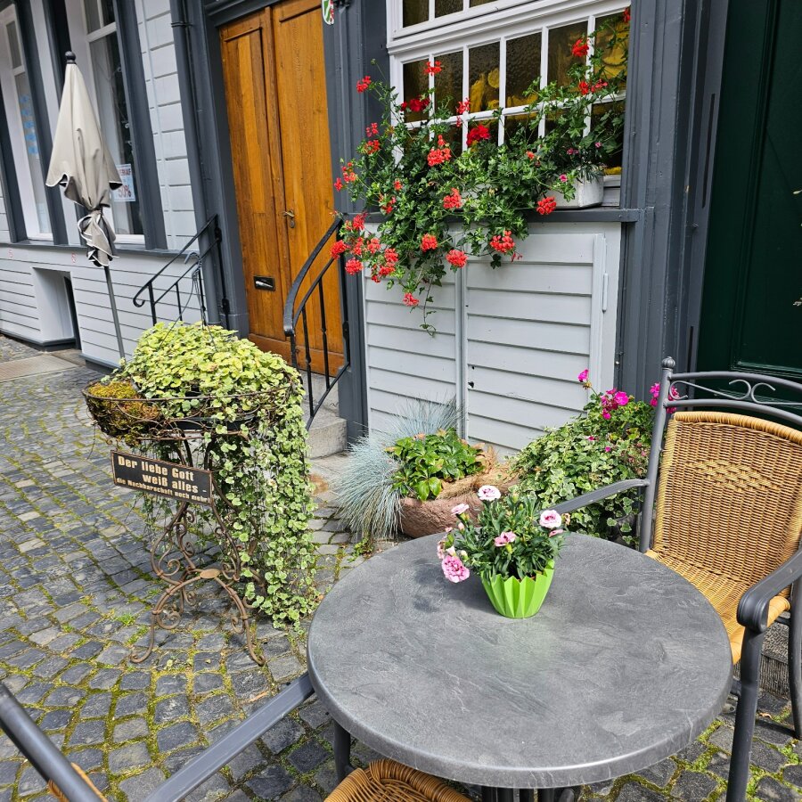 Small terrace with flowers beside a house in Monschau