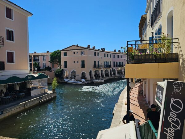 Canal with houses and terraces in Port Grimaud