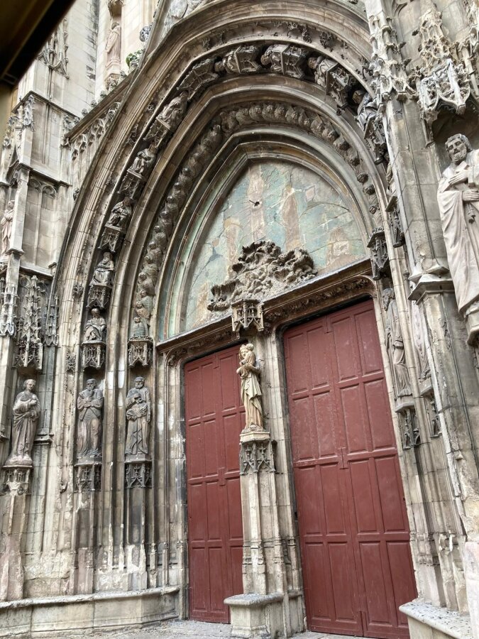 Gothic church portal with red doors in Aix-en-Provence