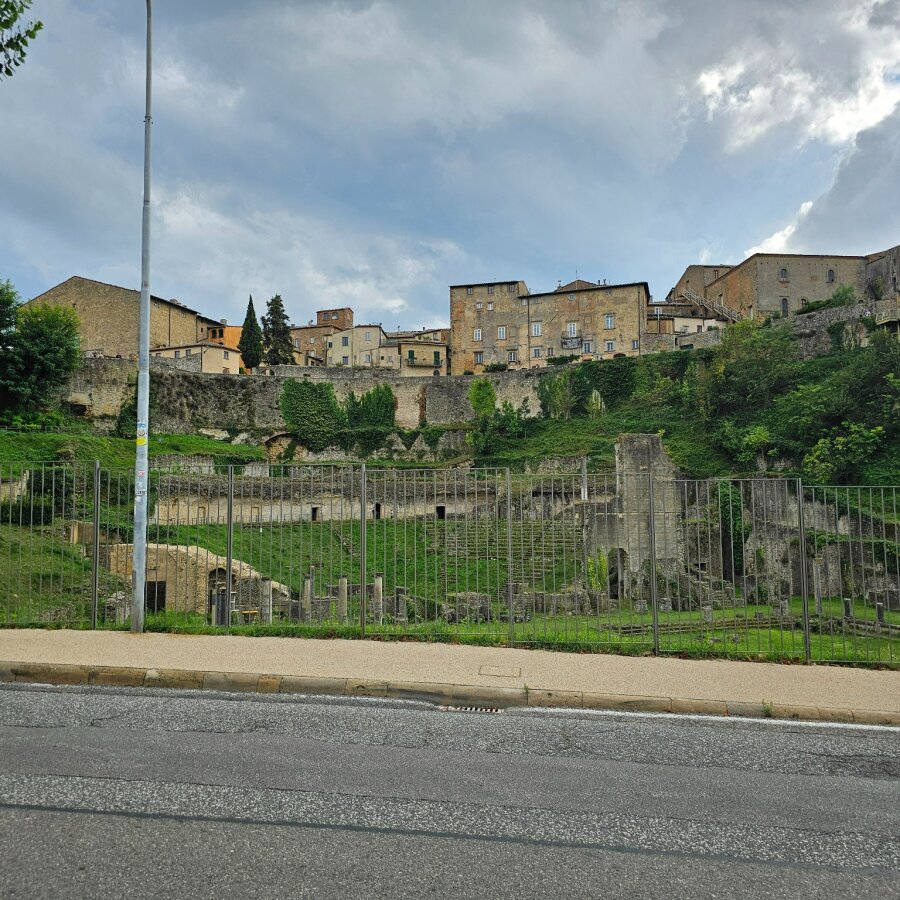 The Roman theatre of Volterra seen from the road