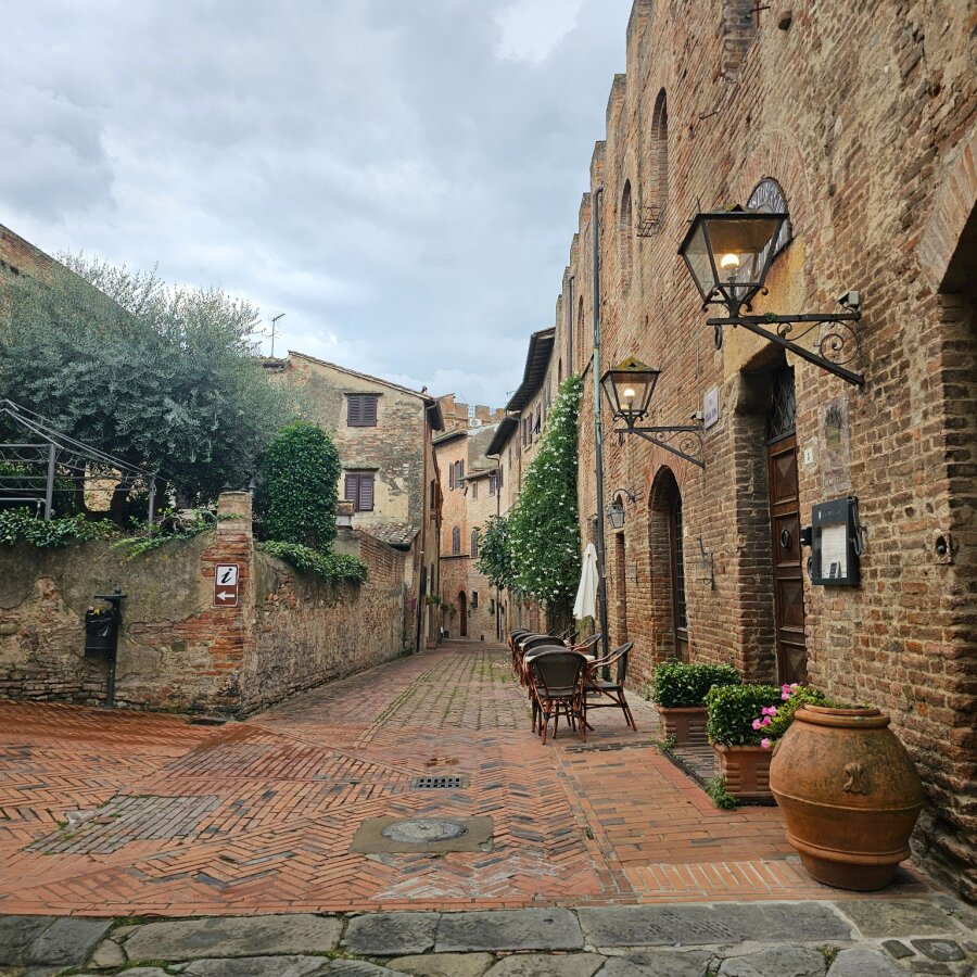 Brick street with a terracotta pot in Certaldo Alto