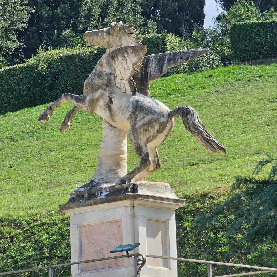 Statue of a horse on a lawn in the Boboli Gardens