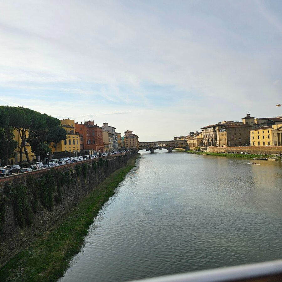 The Arno with a bridge in the distance, seen from the car