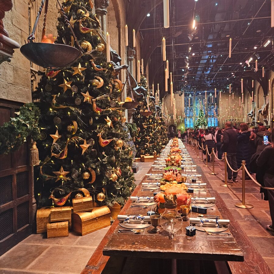 The Great Hall with Christmas trees and the long laid table