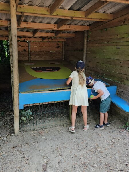 Two children at a wooden puzzle station on the treasure hunt