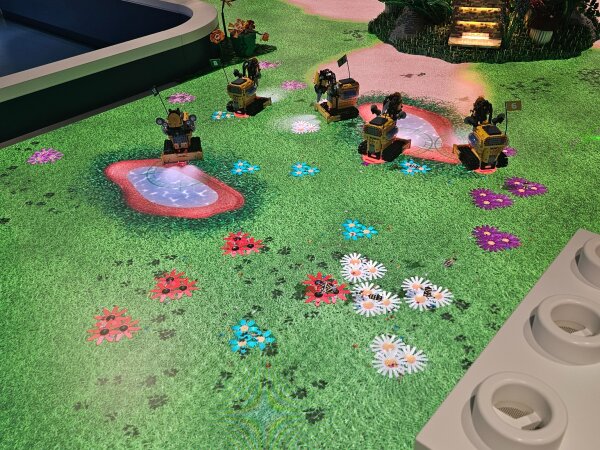 Green LEGO landscape with flowers in one of the experience zones