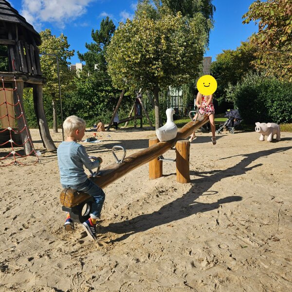 Child on a seesaw in the sandy playground at Center Parcs Hochsauerland