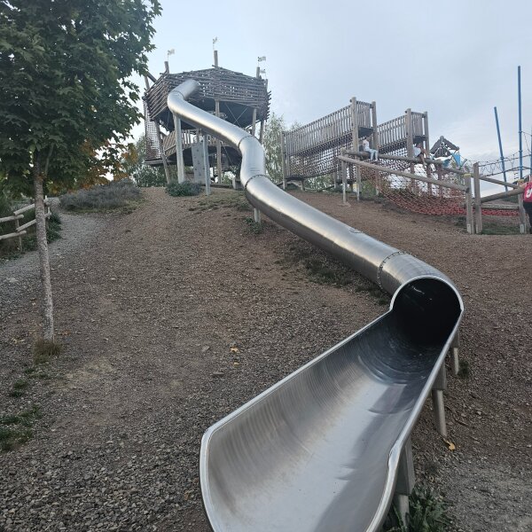 The long metal slide at the bottom of the Aventura playground