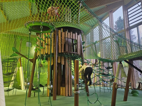 Green climbing net in the indoor play area on the park