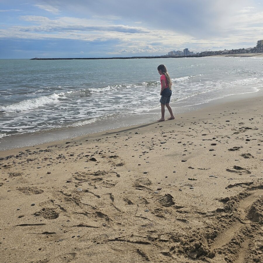Child running along the beach on the Valencia coast