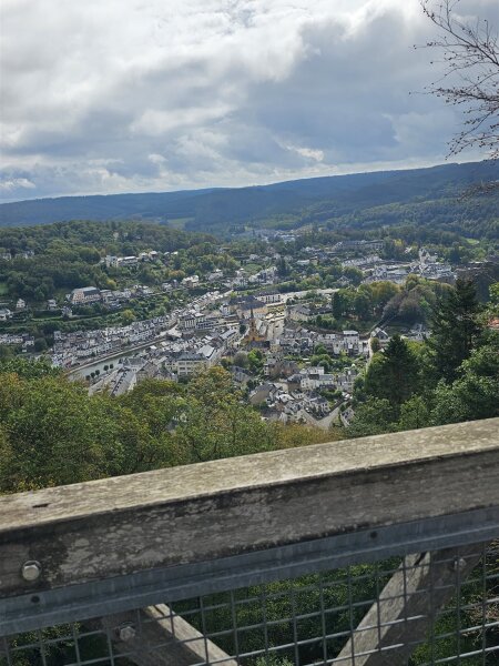 View from a wooden lookout tower over Bouillon in the valley, with wooded hills behind